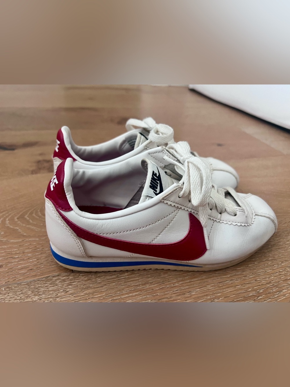 Vintage iconic Nike Women’s White Sneakers with Red Swoosh and Blue Accents